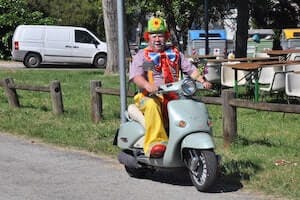 smiling clown on motorcycle